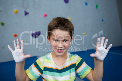 Boy showing powder on hands in studio