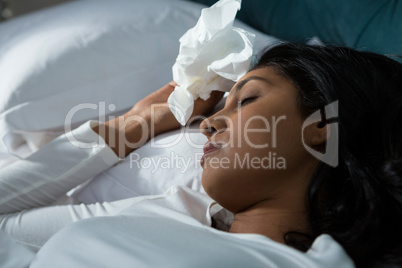 Close-up of sick woman sleeping on bed