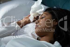 Close-up of sick woman sleeping on bed
