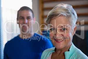 Smiling senior woman standing in hospital