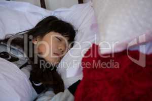 Girl sleeping on bed at home