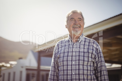 Smiling senior man looking at the sky