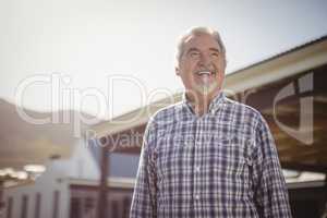 Smiling senior man looking at the sky