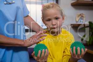 Girl exercising with stress ball in hospital