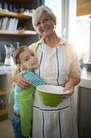 Grandmother and granddaughter embracing in the kitchen