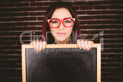 Portrait of smiling woman holding slate