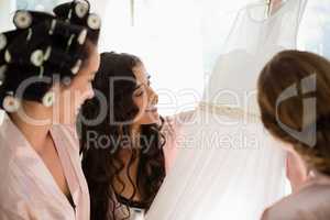 Smiling women looking at wedding dress