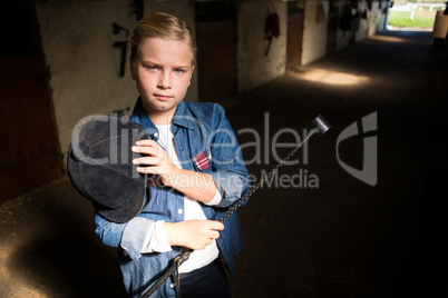 Girl standing in the stable