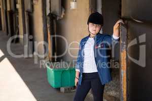 Girl standing in the stable