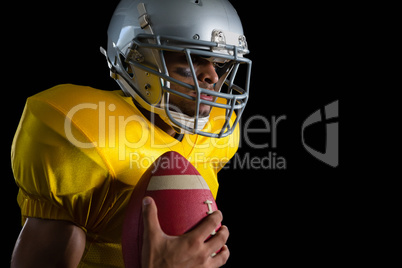 American football player holding a ball