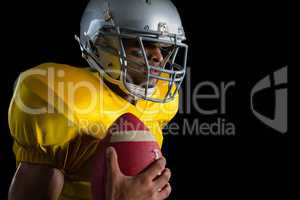 American football player holding a ball