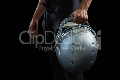 American football player holding a head gear