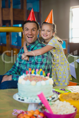 Happy father and daughter celebrating birthday party