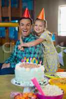 Happy father and daughter celebrating birthday party