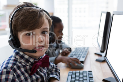 Portrait of businessman working with colleague at desk