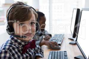 Portrait of businessman working with colleague at desk