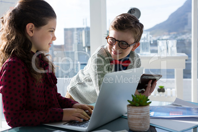 Smiling business people discussing in office Smiling business people discussing in office