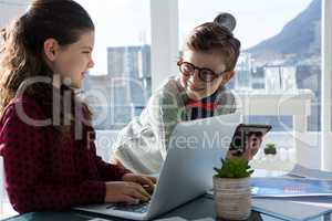 Smiling business people discussing in office