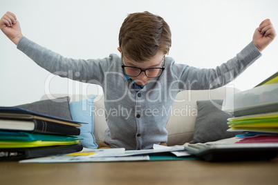 Frustrated businessman with arms outstretched sitting on sofa