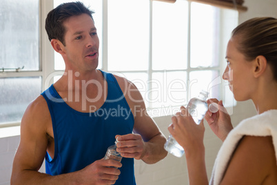 Athletes drinking water in gym