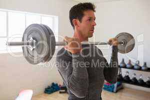 Athelte lifting barbell at gym