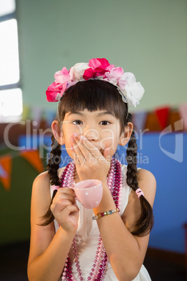 Portrait of cute girl holding teacup during birthday party