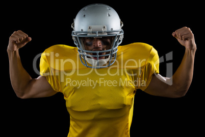 American football player flexing his muscles