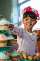 Girl having cupcake during birthday party