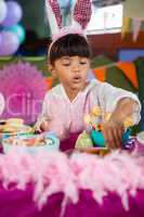 Girl having cookies during birthday party
