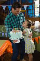 Father and daughter celebrating birthday at home