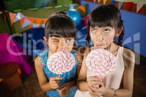 Kids holding a lollipop during birthday party