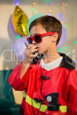 Cute boy pretending to be a fireman during birthday party