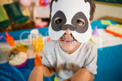 Boy pretending to be a dog during birthday party