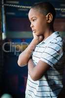 Thoughtful boy standing near window