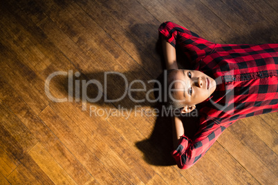 Portrait of cute boy relaxing on wooden floor