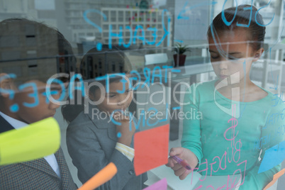 High angle view of colleagues discussing seen through glass