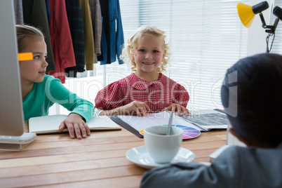 Portrait of smiling businesswoman working with colleagues in office