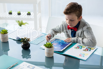 High angle view of businessman reading documents while sitting at desk