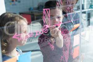 Businesswoman explaining graph to colleagues seen through glass