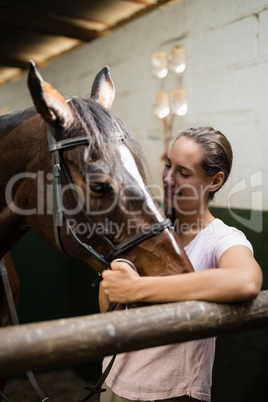 Smiling jockey standing by horse