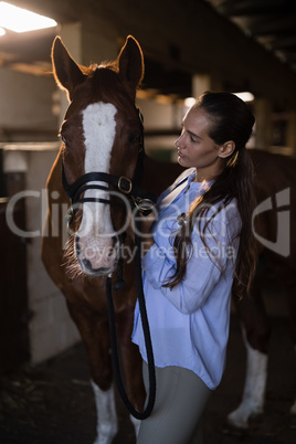 Female vet examining brown horse