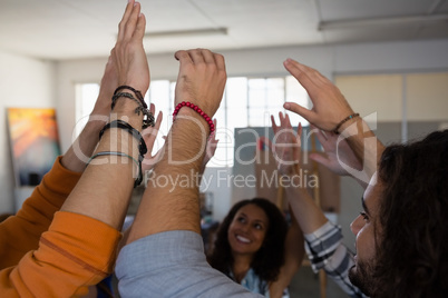 Happy friends with arms raised