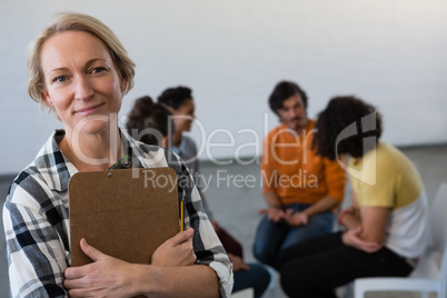 Portrait of teacher with students in background