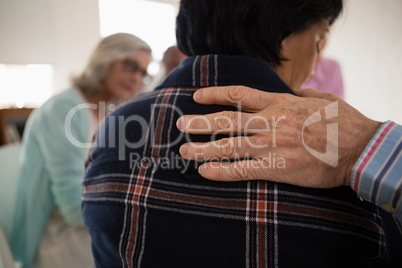 Cropped hand on man on female friends shoulder