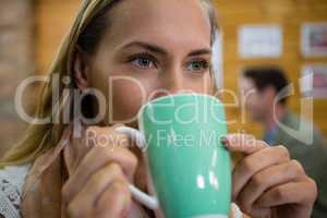 Close of thoughtful woman having coffee in cafe