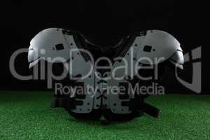 American football shoulder pads over artificial turf