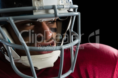 Determined American football player with a head gear