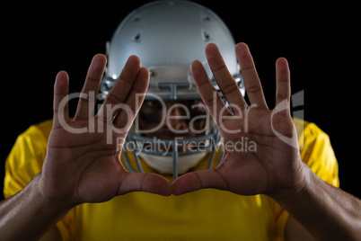 American football player showing hand gestures