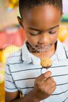 Cute boy holding lollipop during birthday party
