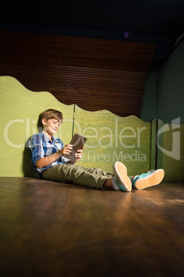 Cute boy using digital tablet at home